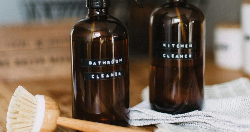two brown spray bottles on brown table