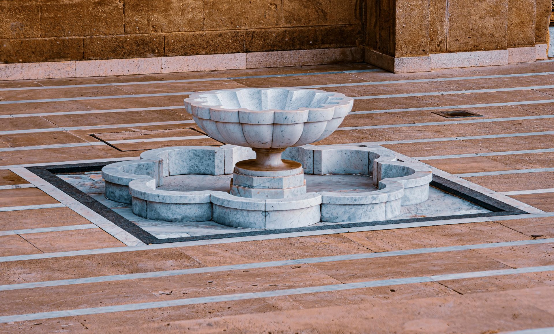 Intricately designed marble fountain in a Moroccan courtyard, showcasing artistic elegance.