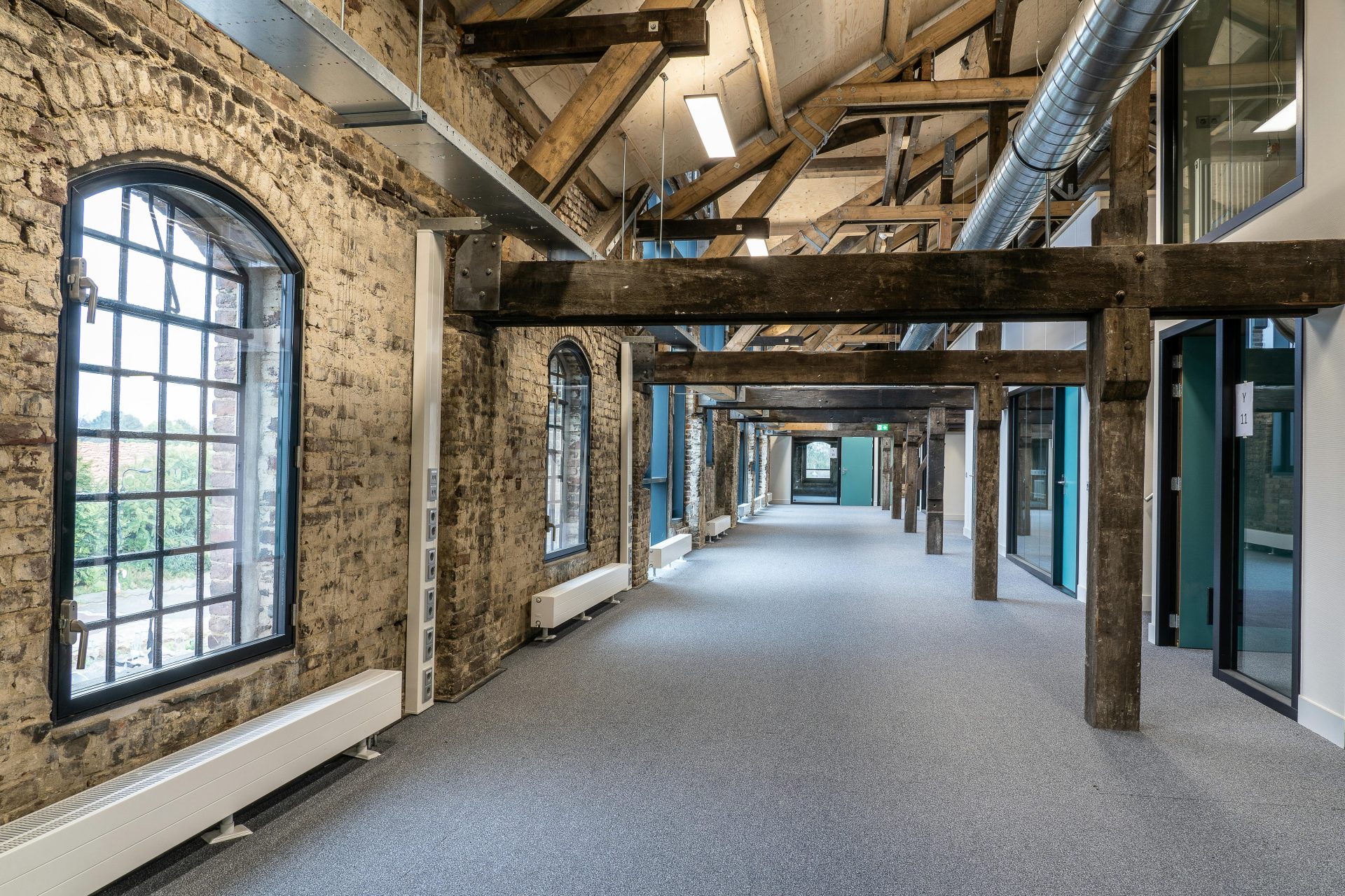 A stylish fusion of modern and rustic in a spacious office hallway interior.